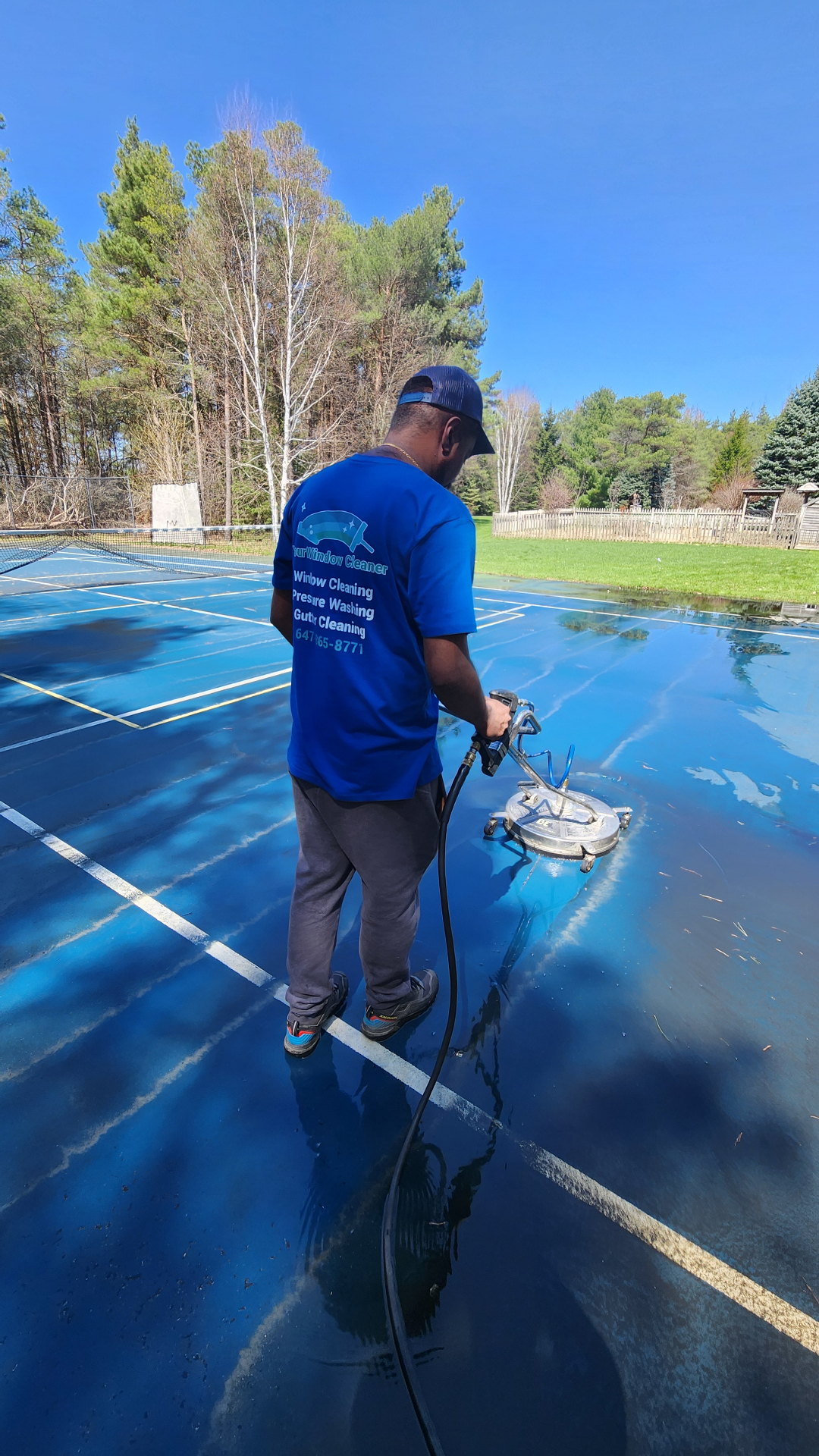 Pressure washing a private tennis court in Nobleton, Ontario